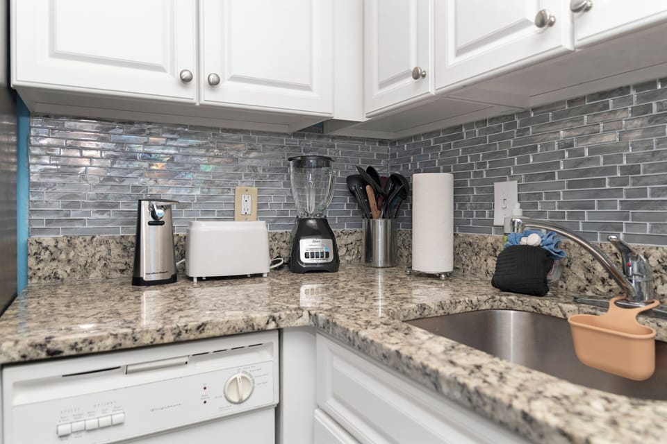 Prepare meals in a well-appointed kitchen featuring granite countertop.
