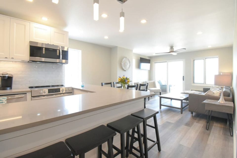 Open-concept kitchen and living space with bar seating, modern finishes, and plenty of room to gather and relax.