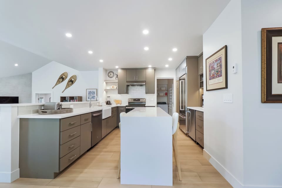 This spacious, modern kitchen invites you to prepare memorable meals with ample counter space, stainless steel appliances, and plenty of natural light streaming through open sightlines.