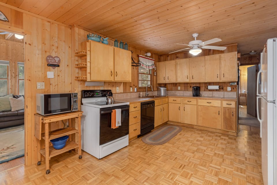 An open concept kitchen area equipped with everything needed to prepare a meal.