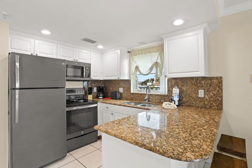 Full Kitchen With Stainless Steel Appliances.