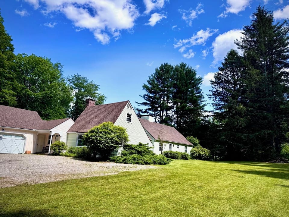 front entrance with a view of the expansive lawn 