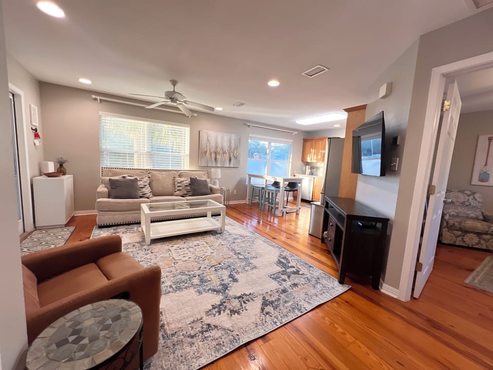 Great room with comfortable couch, recliner and smart tv.