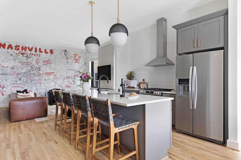 Clean and Spacious Kitchen with Sleek Countertops and Additional Seating
