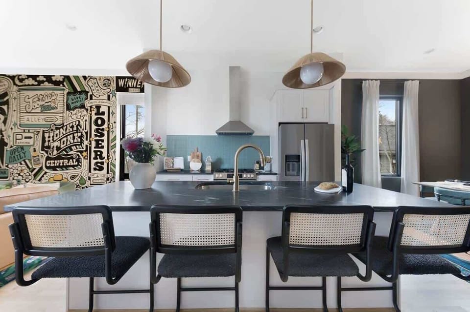 Clean and Spacious Kitchen with Sleek Countertops and Additional Seating
