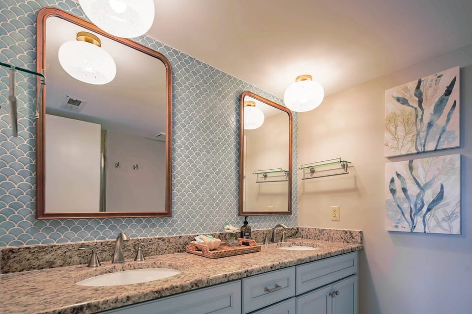 The en suite bathroom features a dual sink vanity.
