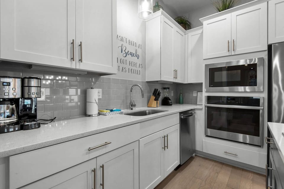 Fully equipped kitchen with oven, microwave, dishwasher, coffee pot and granite countertops
