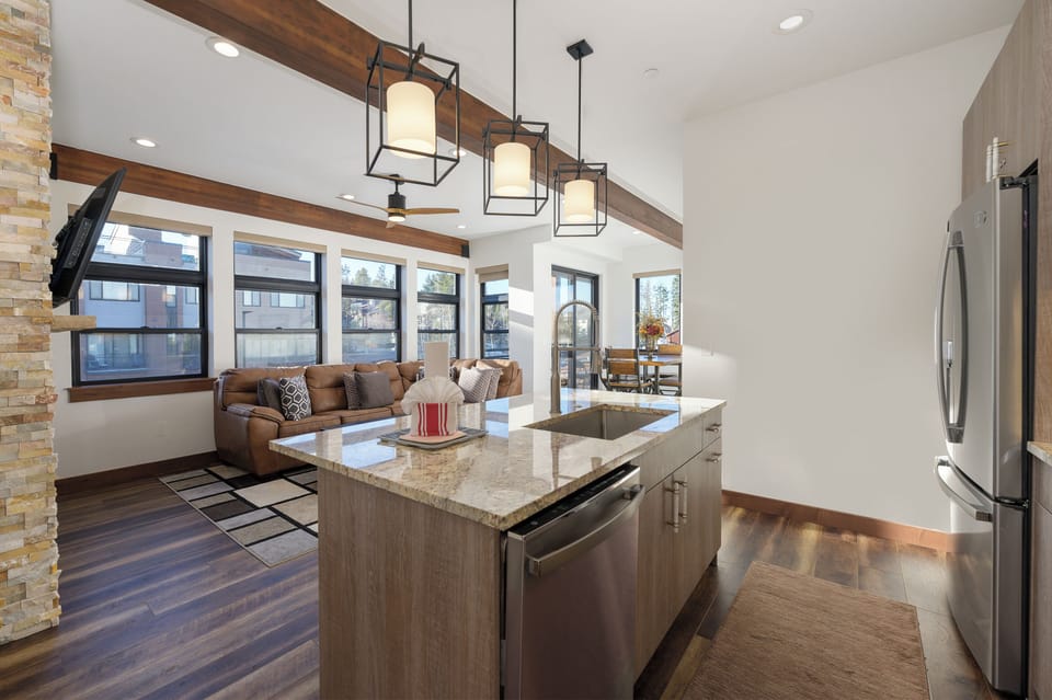 Cook and entertain seamlessly in your modern kitchen with granite countertops, stainless appliances, and open flow to your cozy living area.