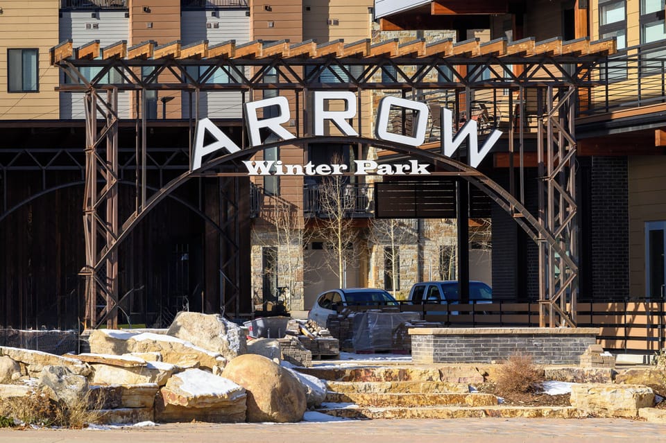 The Arrow Winter Park entrance welcomes guests to this modern mountain retreat with its distinctive architectural design and stone features.