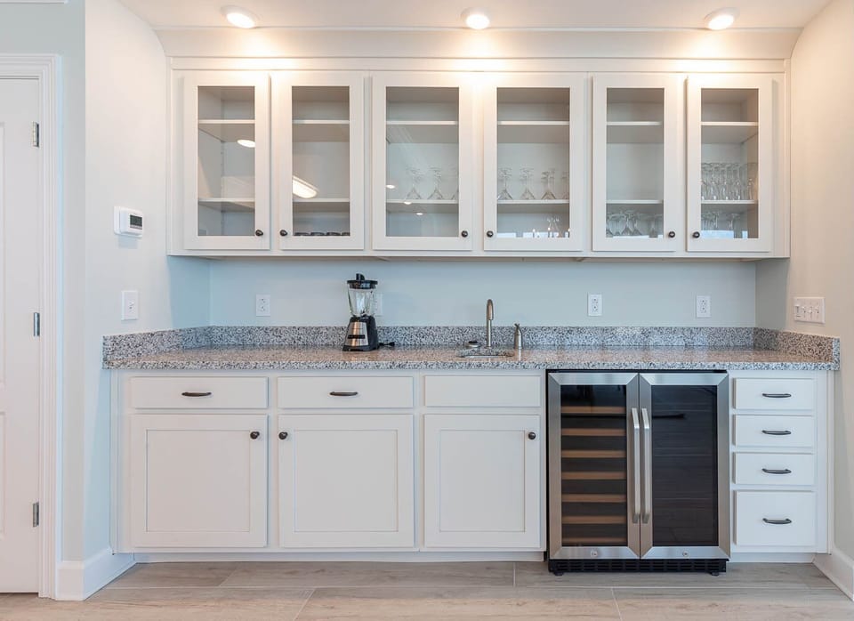 Sip chilled wine from the wine cooler and grab stemware from the glass-front cabinets at the wet bar