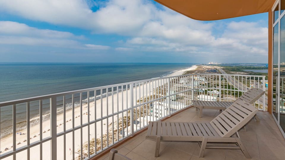 Relax on loungers at the beachfront balcony, feeling gulf breezes and enjoying seemingly endless coastline views