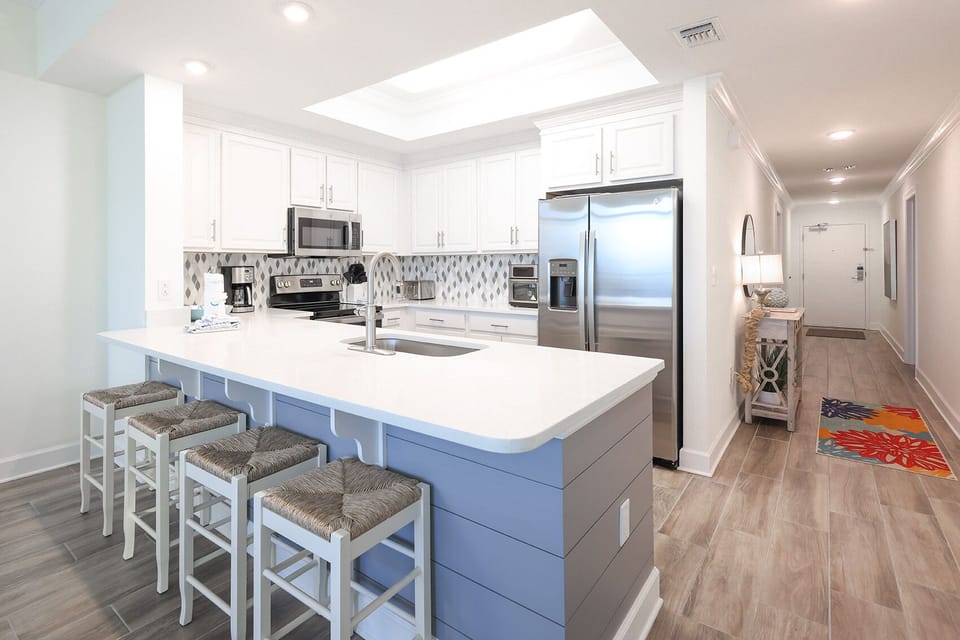 Sip your morning coffee at the breakfast bar and get ready for a beach day in this stylish space