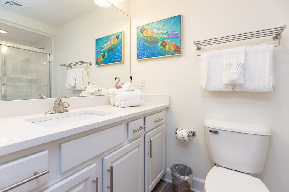 Freshen up in this guest bath in the relaxing shower or soothing tub before an exciting beach day