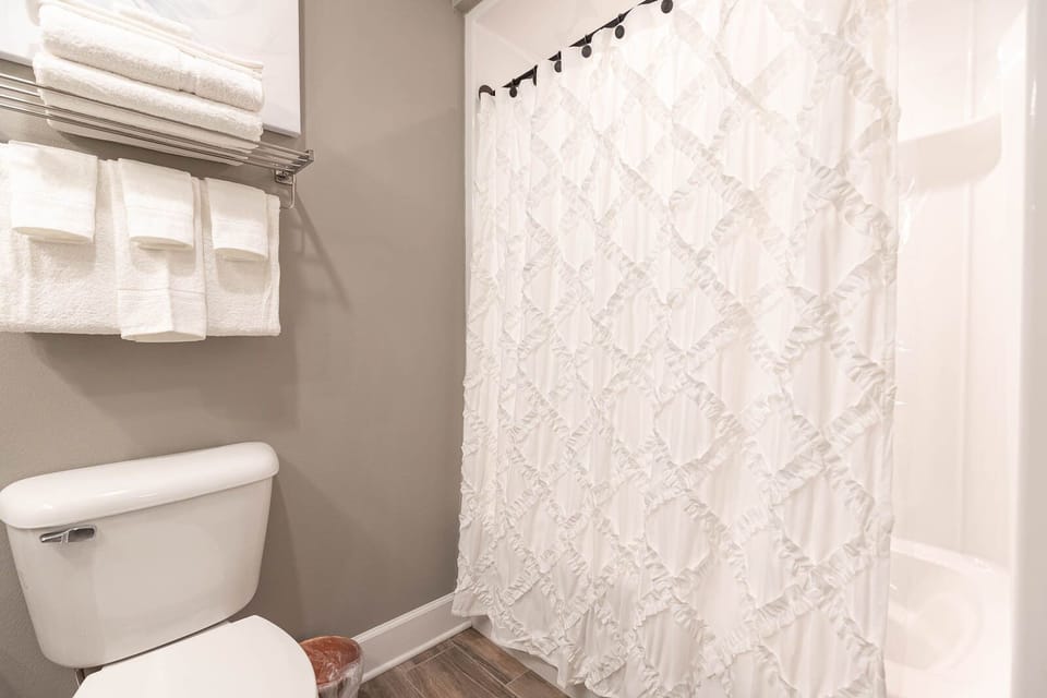Enjoy a refreshing shower in this guest bath and dry off with plush towels for a comfortable stay