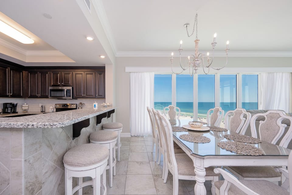 Gather in this stylish dining space and enjoy gulf breezes with panoramic beachfront views