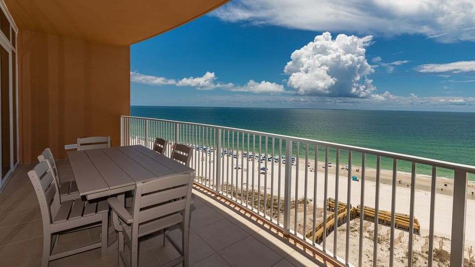 Relax on the balcony, sit at the table, and watch the gulf and shoreline below