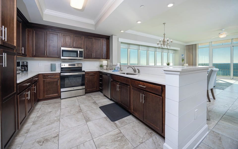 Brew morning coffee or prepare family meals in this inviting kitchen with rich cabinetry and stainless appliances