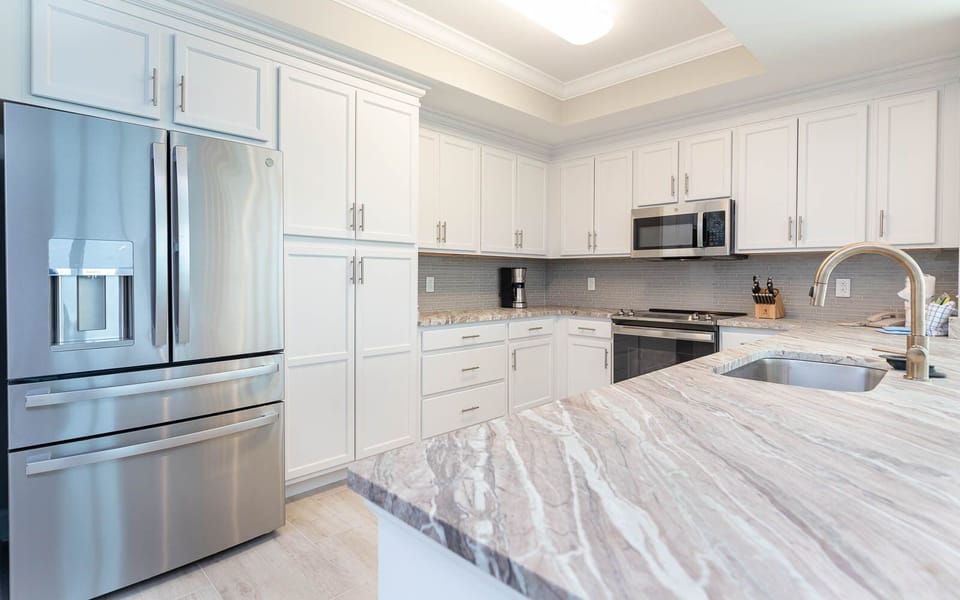 Prepare meals in this upgraded kitchen with elegant countertops, modern stainless appliances, and stylish cabinetry