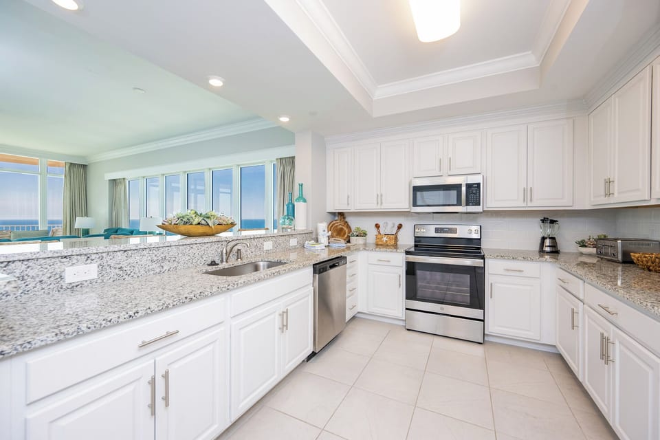 Prepare meals in this kitchen with elegant cabinetry, stainless appliances, and spacious countertops