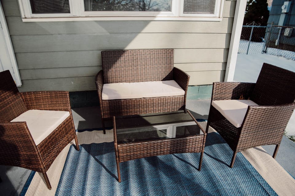 Outdoor sitting area on covered patio in back yard