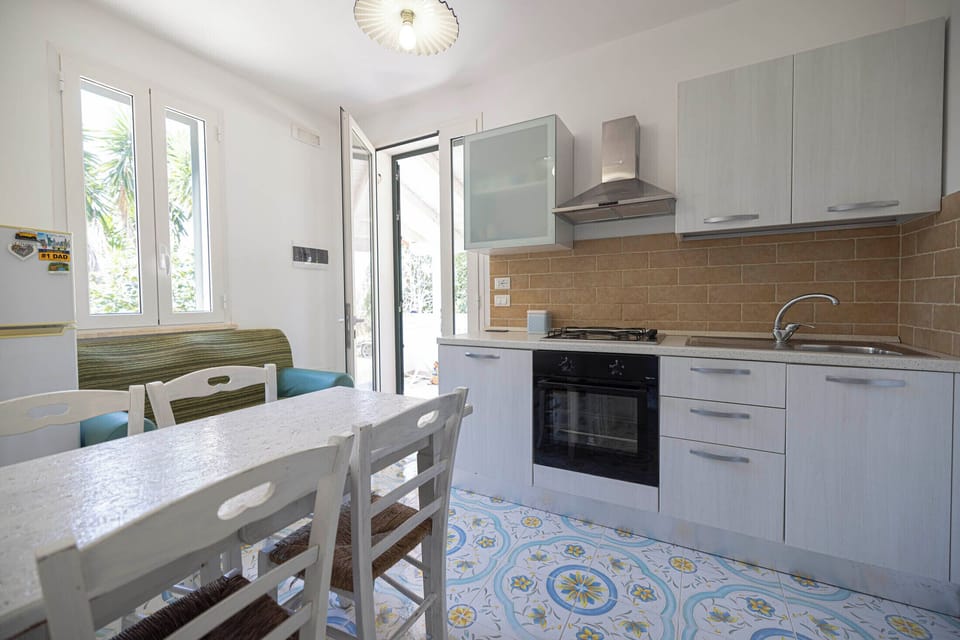 Premium Quadruple Room | Private kitchen | Dining tables