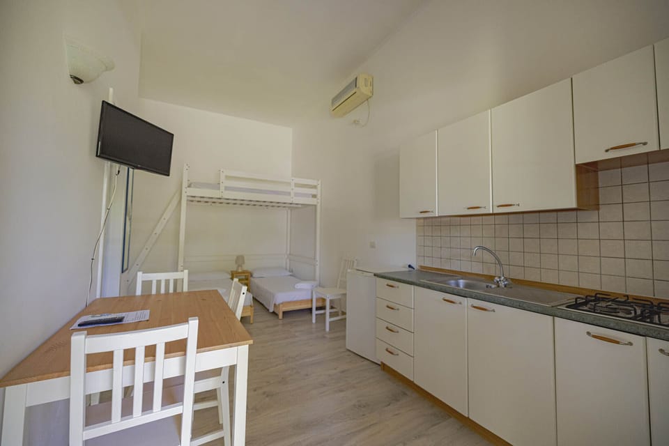 Superior Quadruple Room | Living area | 42-inch flat-screen TV with digital channels, printers