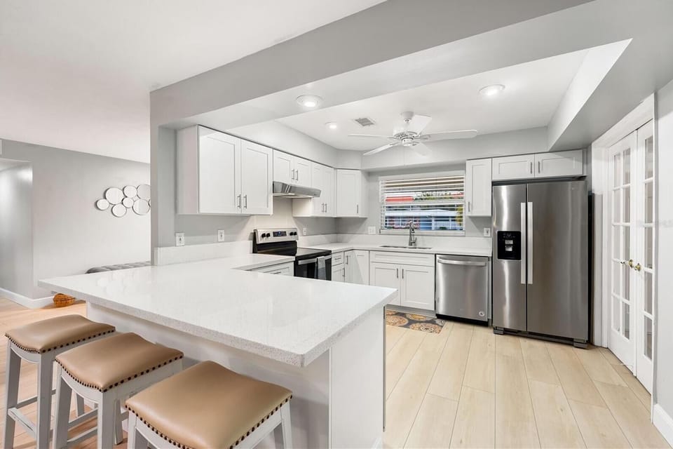 Fully stocked kitchen, stainless steel appliances, Keurig and drip coffee makers, and a breakfast bar with seating area. Perfect for large families wanting a space for at-home meals.