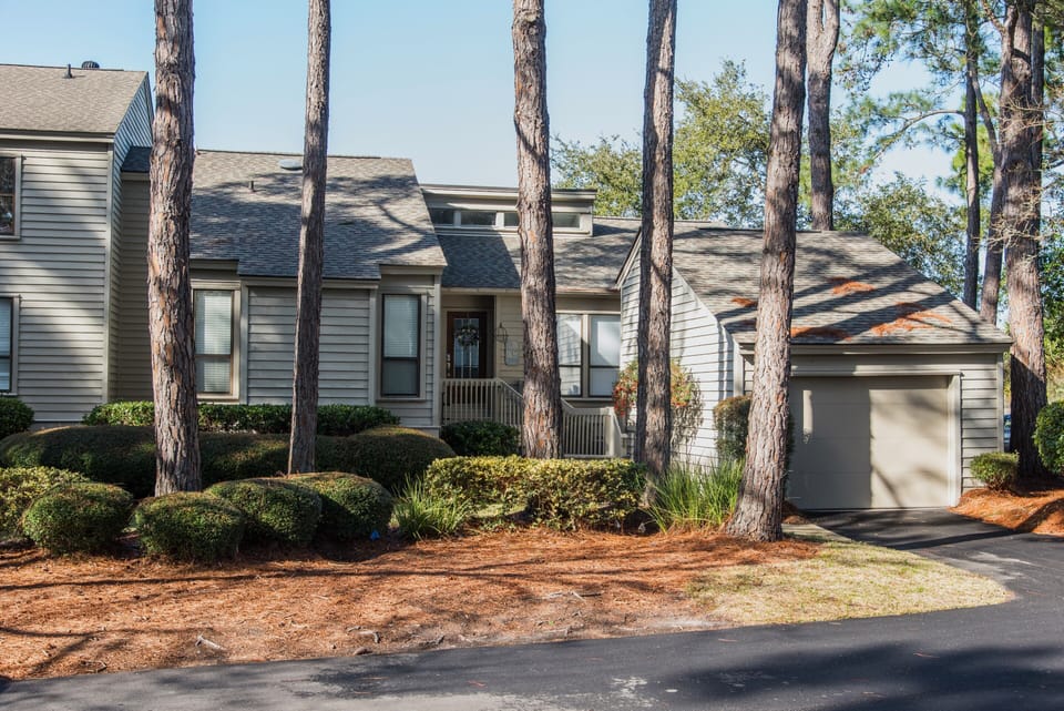 Outside view of the front of this end unit villa w/ garage