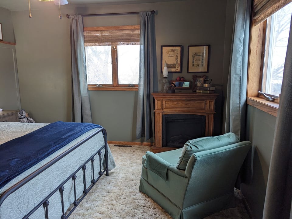 Green Spindle Hideaway bedroom with fireplace and queen size bed