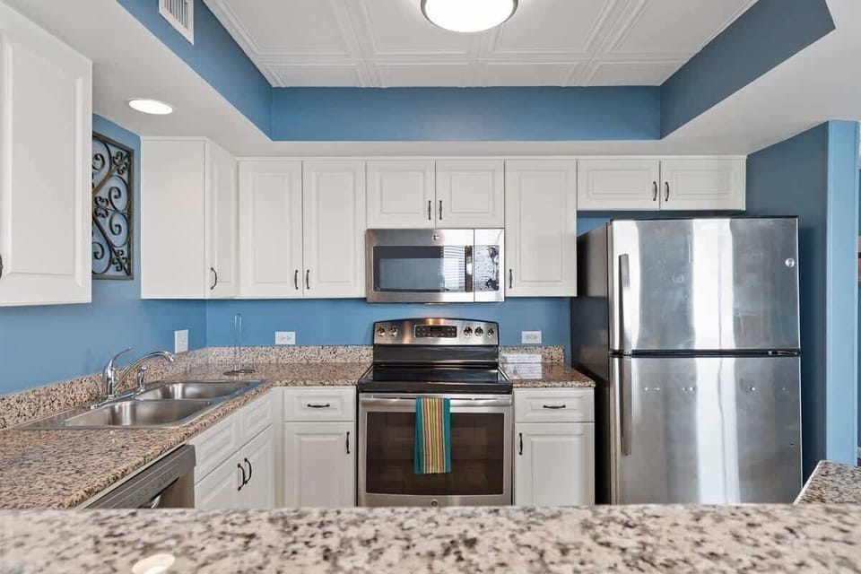 - Kitchen with stainless steel appliances and granite tops   - White cabinetry adds bright coastal charm to cooking   - Fully equipped for easy meal prep in Myrtle Beach condo