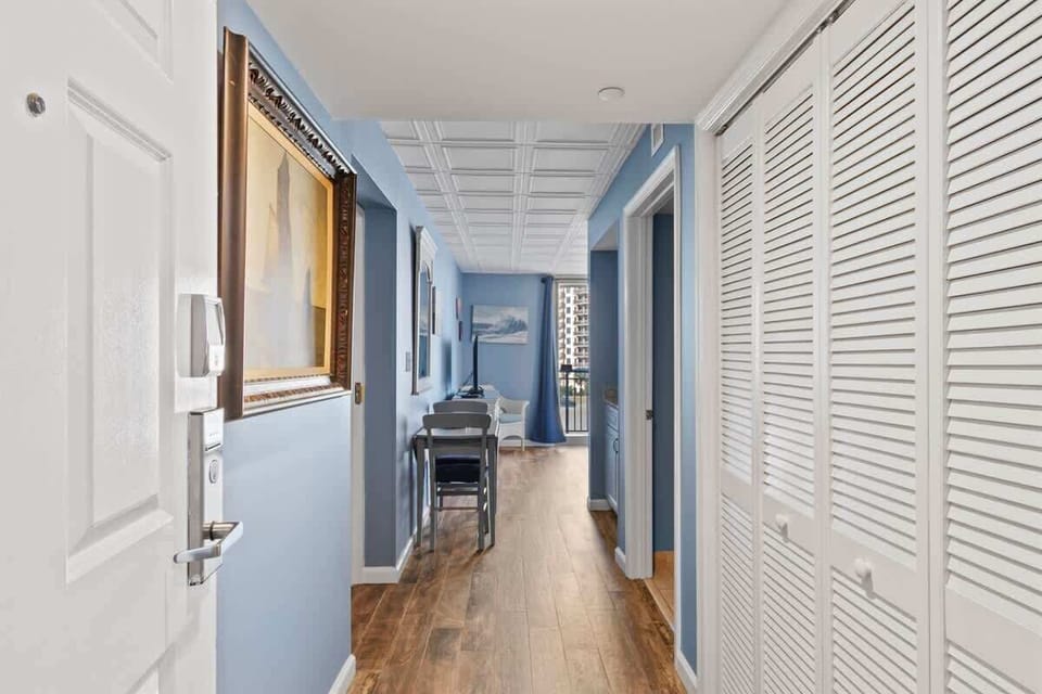 - Entry hallway with coastal décor and wood style flooring   - Leads into bright open living spaces with oceanfront views   - Welcoming design sets the tone for your Myrtle Beach stay