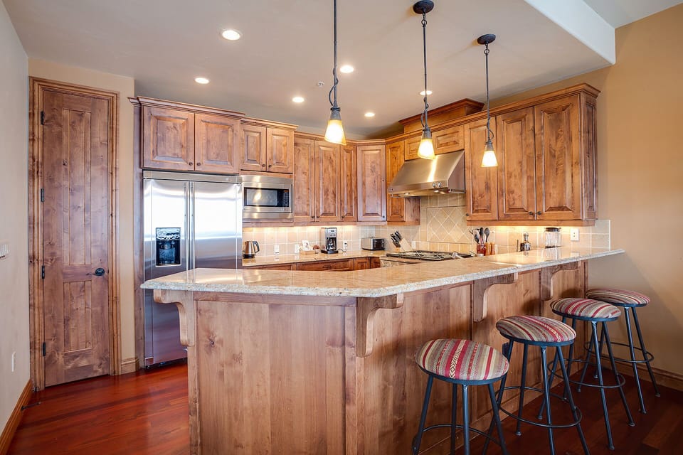 Your gourmet kitchen awaits with granite counters, rich wood cabinets, and modern appliances for memorable meals together.