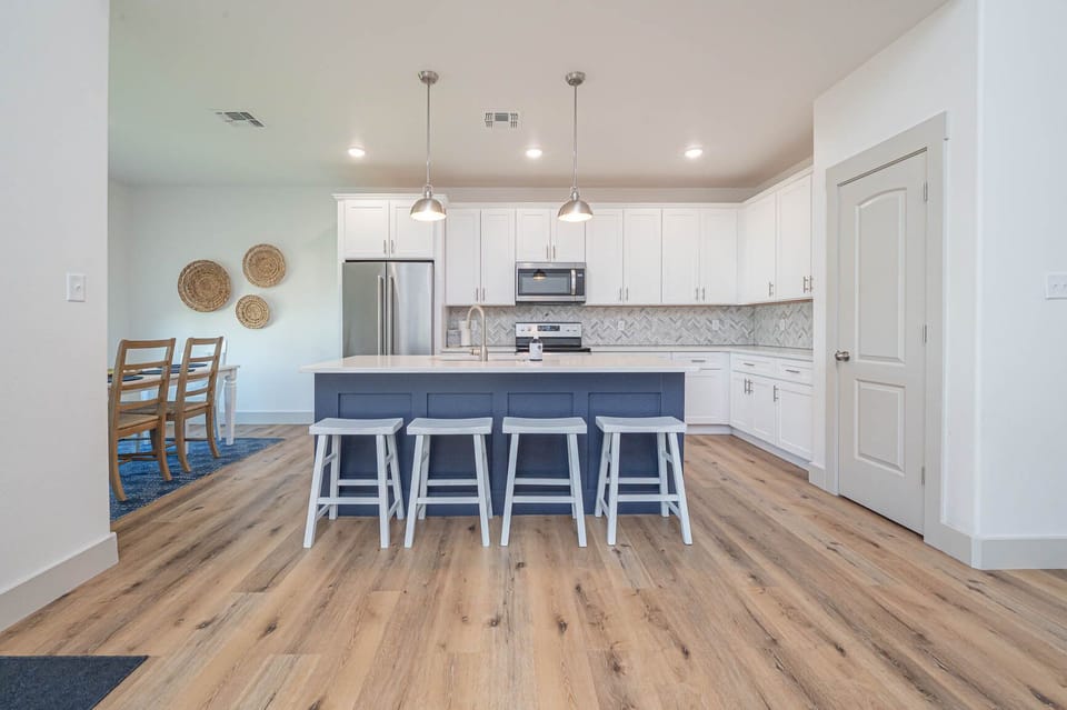 Bright open-concept living area with comfy seating and sleeper sofa — perfect for relaxing after a day on the water