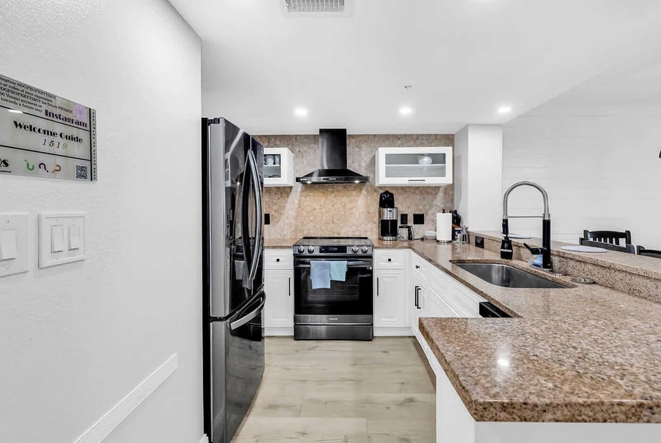 New Kitchen with Black stainless steel appliances, vented hood, induction cooktop w/air fryer, microwave, toaster, all utensils and more.