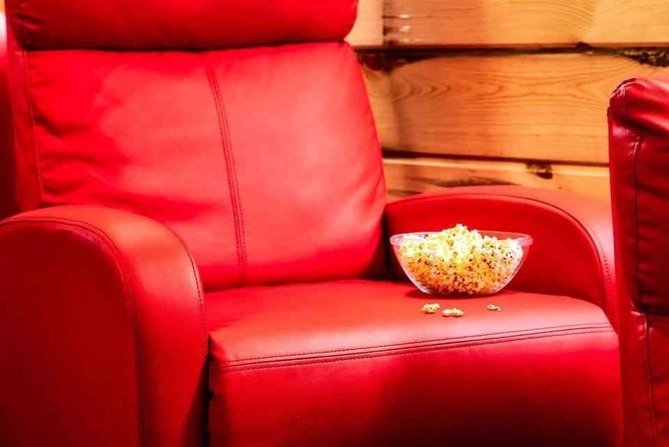 red leather armchair with a bowl of popcorn for a cozy movie night