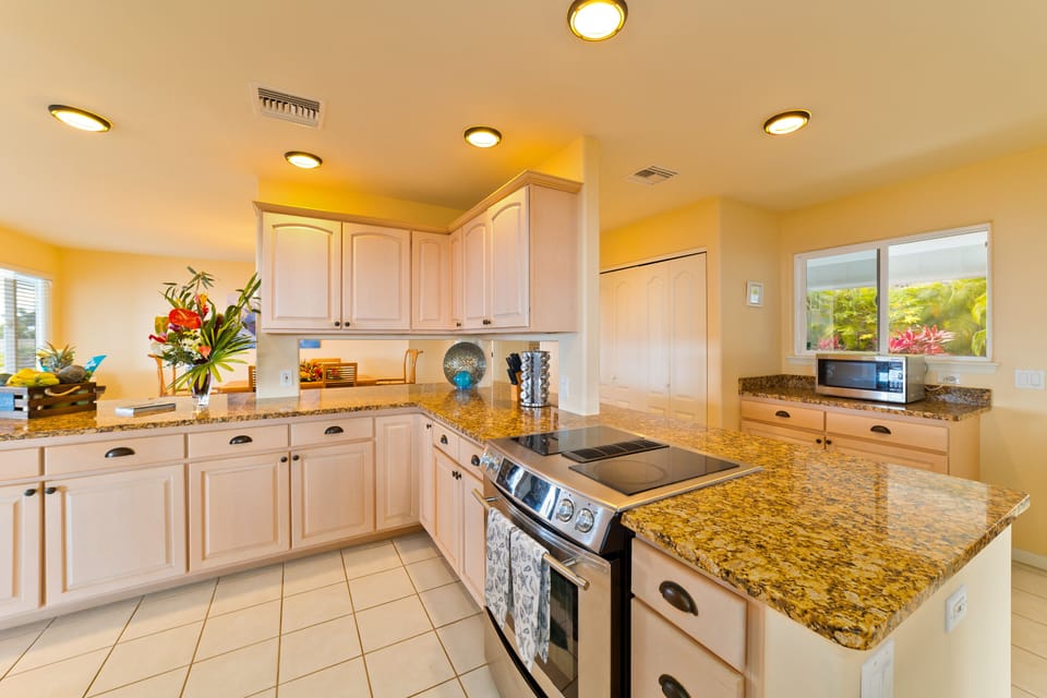 Kitchen with nicely appointed appliances and beautiful granite counter tops