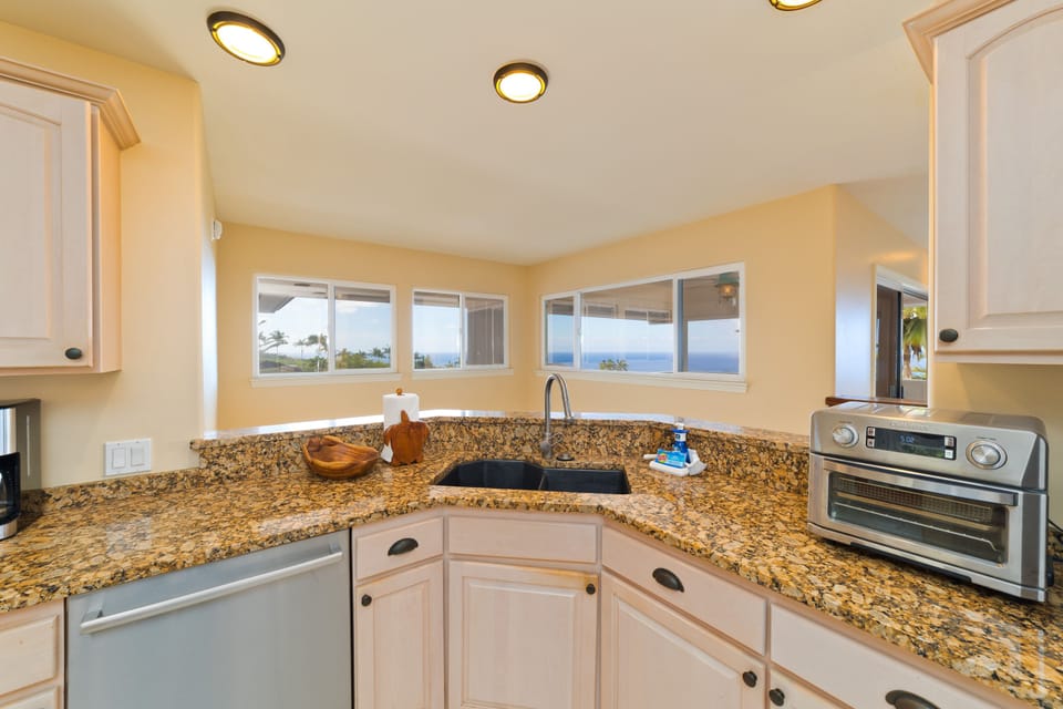 Kitchen with nicely appointed appliances. You will find almost everything, and more, even the most discerning chef might require, from bread maker to a toaster oven for a quick meal options.