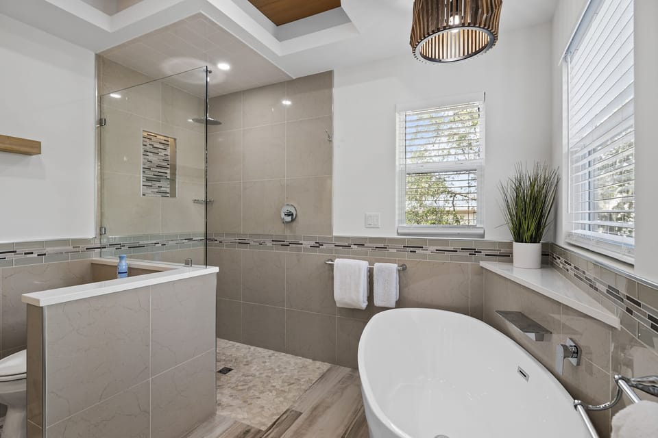 Large master bathroom with dual vanity, walk in shower, and soaker tub