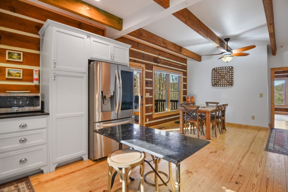 Open concept kitchen with premium refrigerator and dinning table 