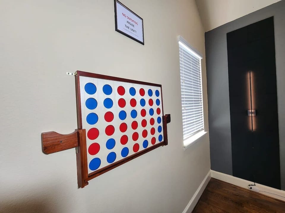 Indoor game zone with giant Connect Four and playful family moments.
