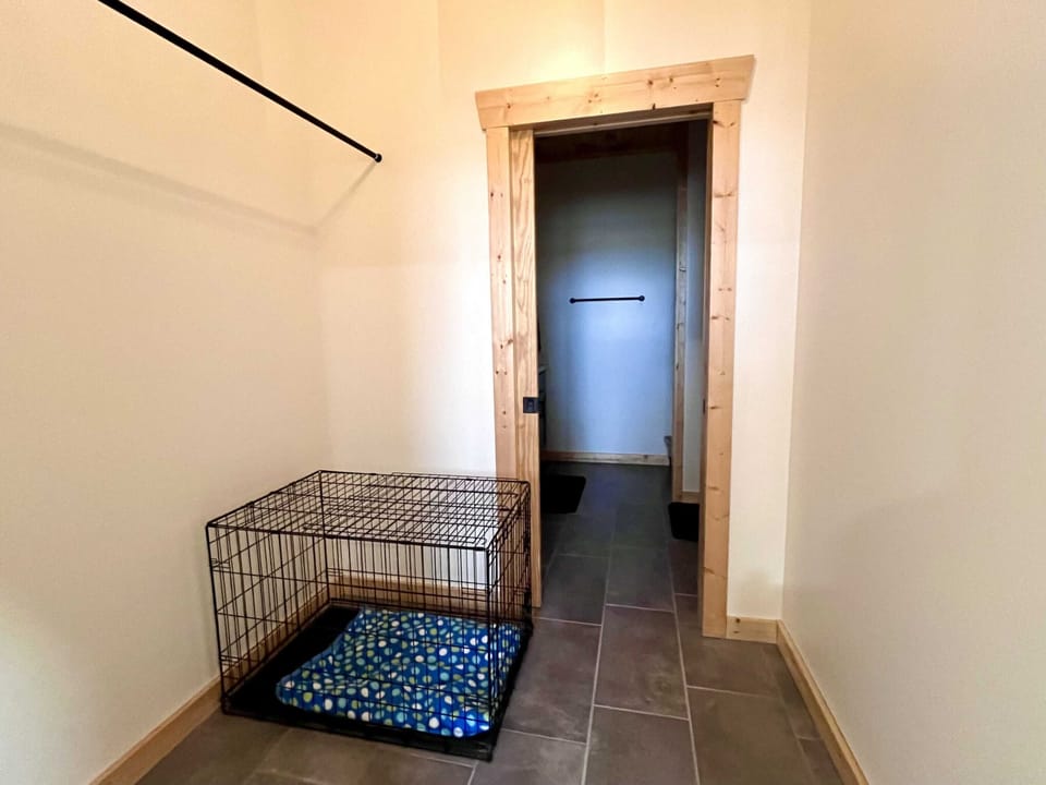 Dog crate and master closet leading into master bath