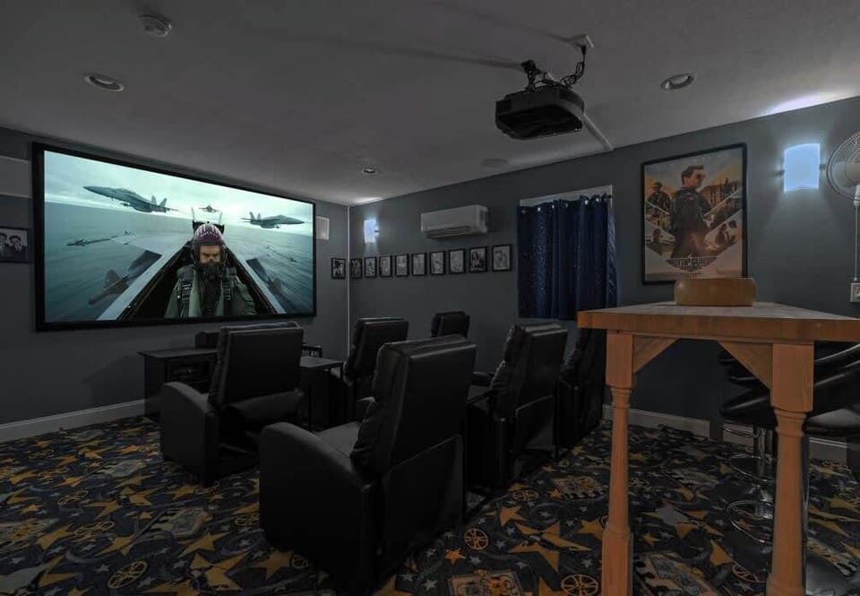 The movie theater has six reclining seats and four additional seats at the elevated table.