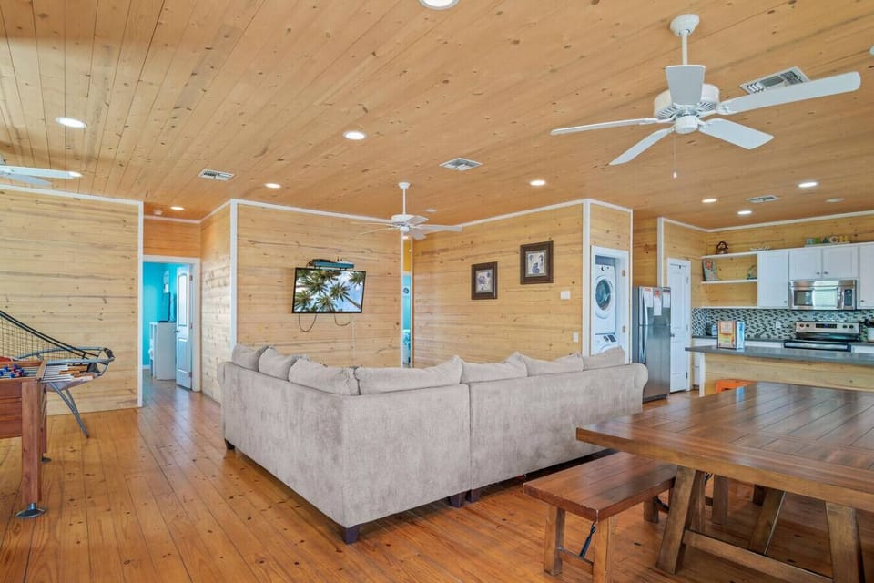Open-concept living with kitchen & laundry access.