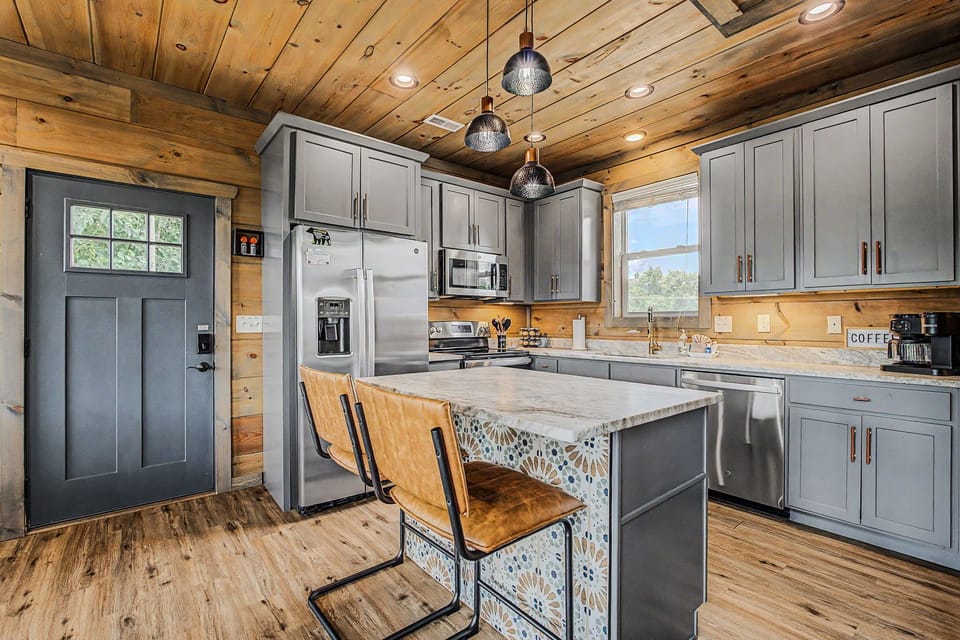 The fully stocked kitchen offers a large island and room to cook together.