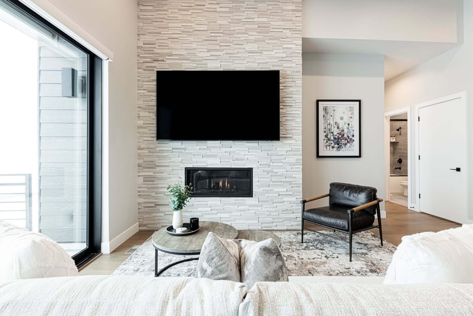 Entry/3rd level with a gas fireplace and 85" Smart TV