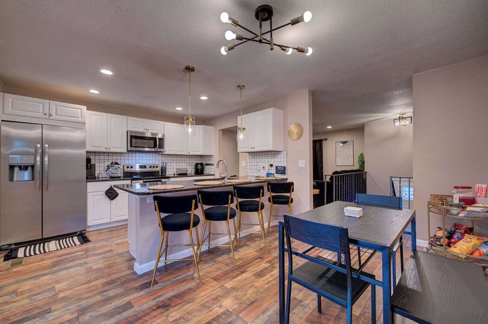A chic-modern kitchen featuring stainless steel appliances plus a coffee bar
