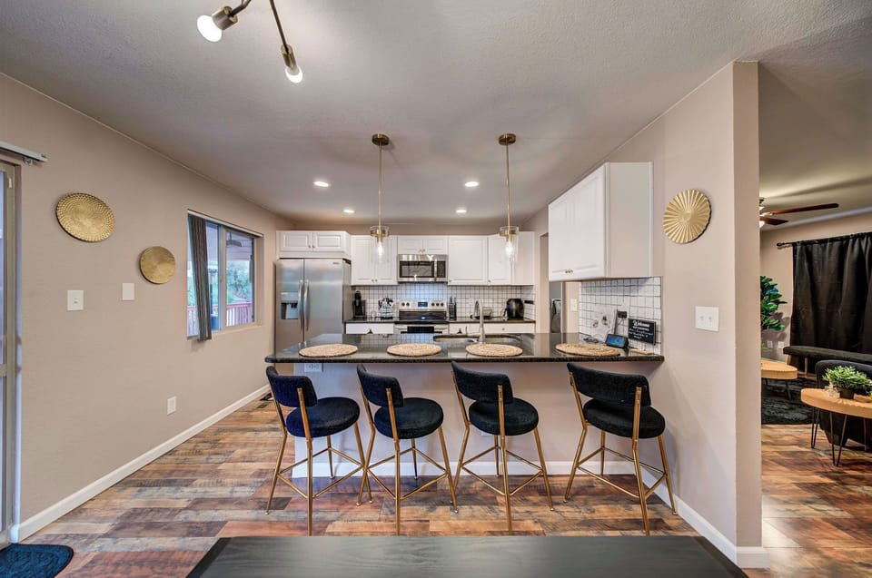 A stylish kitchen with bar seating, pendant lights, and plenty of cabinet space.
