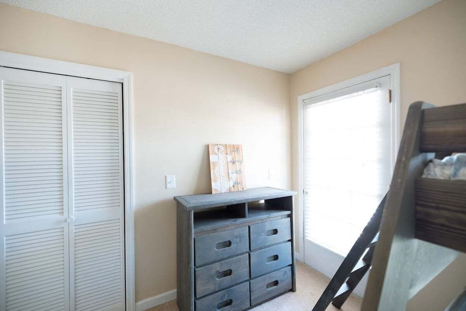 Perfect for kids or groups, this bedroom features two twin-over-full bunk beds, maximizing sleeping space and functionality.