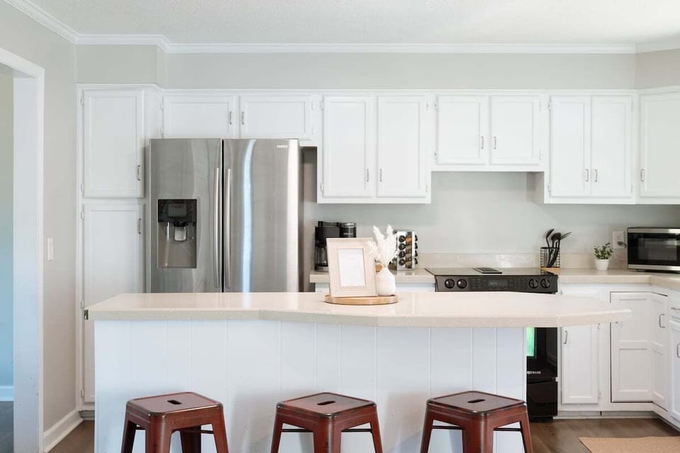 Modern kitchen fully equipped with appliances, cookware, spices, and a Keurig Duo coffee maker