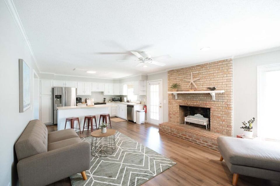 Bright and airy open-concept living space with comfortable seating and a Smart TV